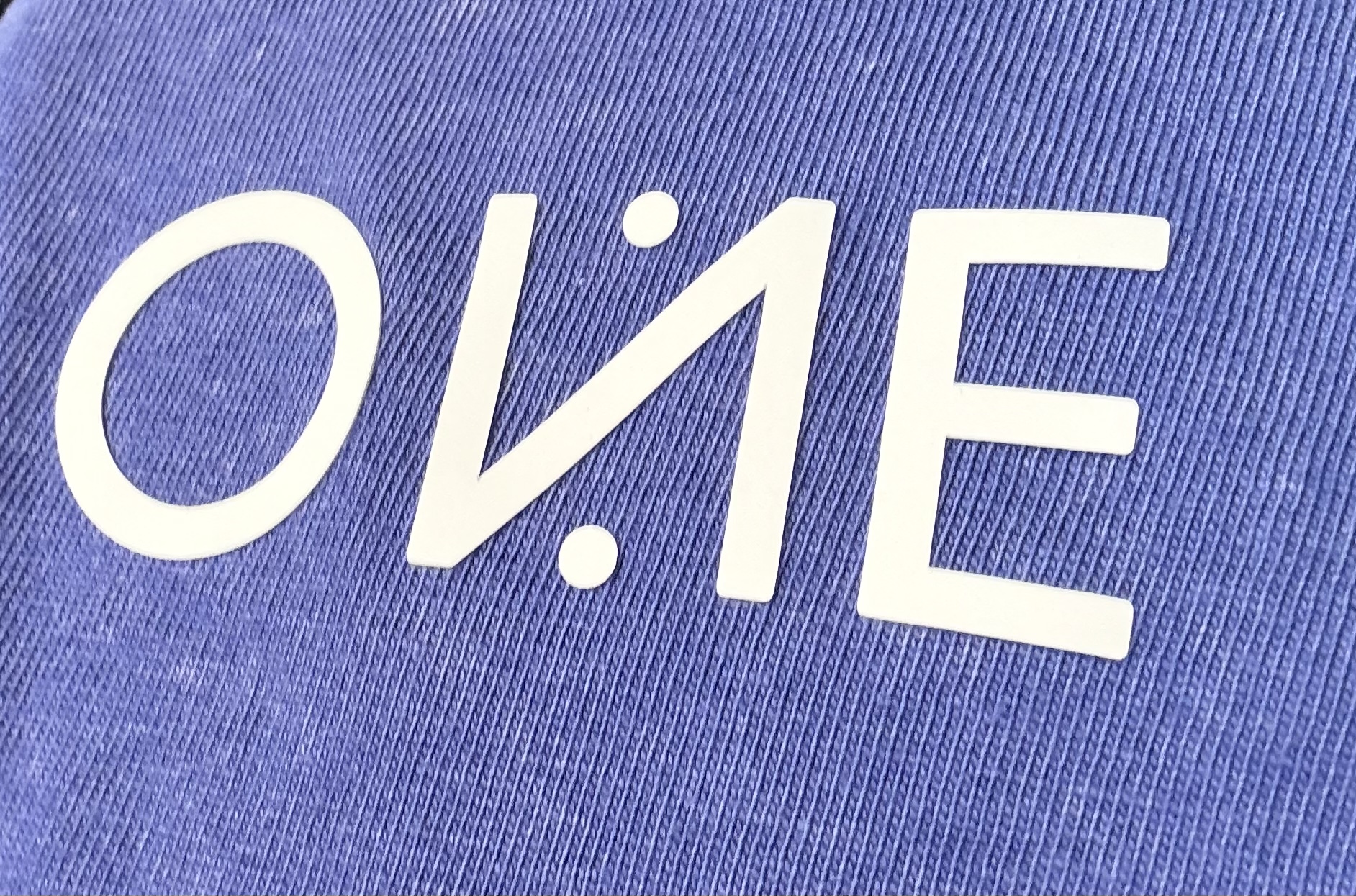 The OnePercent mark printed on periwinkle knit
